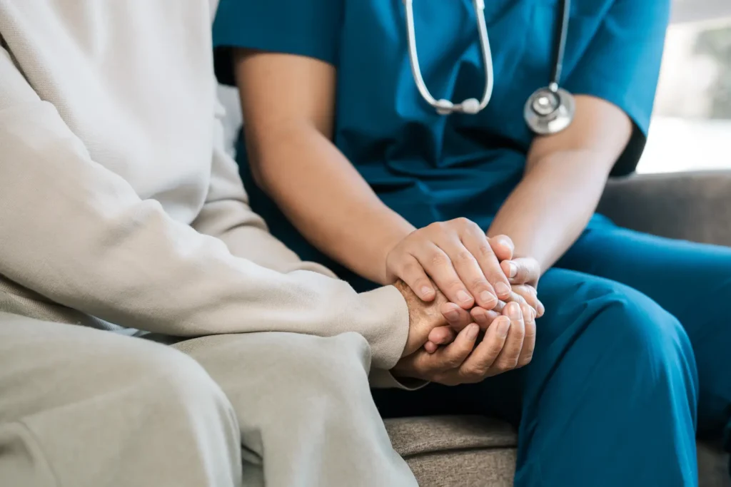nurse holding a patients hand